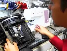Vacuum repair technician servicing internal components on a workbench in Wilmington, NC
