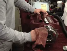 Vacuum repair technician cleaning and servicing a vacuum motor in Wilmington, NC