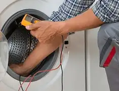Washing machine repair technician testing a front-load washer with diagnostic tools in Wilmington, NC